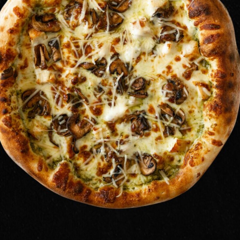 The Half Pint Chicken Pesto Pizza with pesto, grilled chicken, mushrooms, and mozzarella.