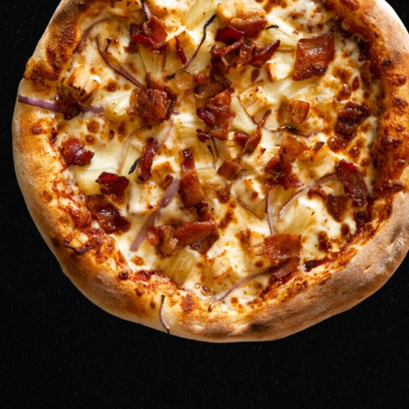 The Half Pint Island BBQ Pizza with Huckleberry BBQ sauce, bacon, chicken, red onions, pineapple, and mozzarella.